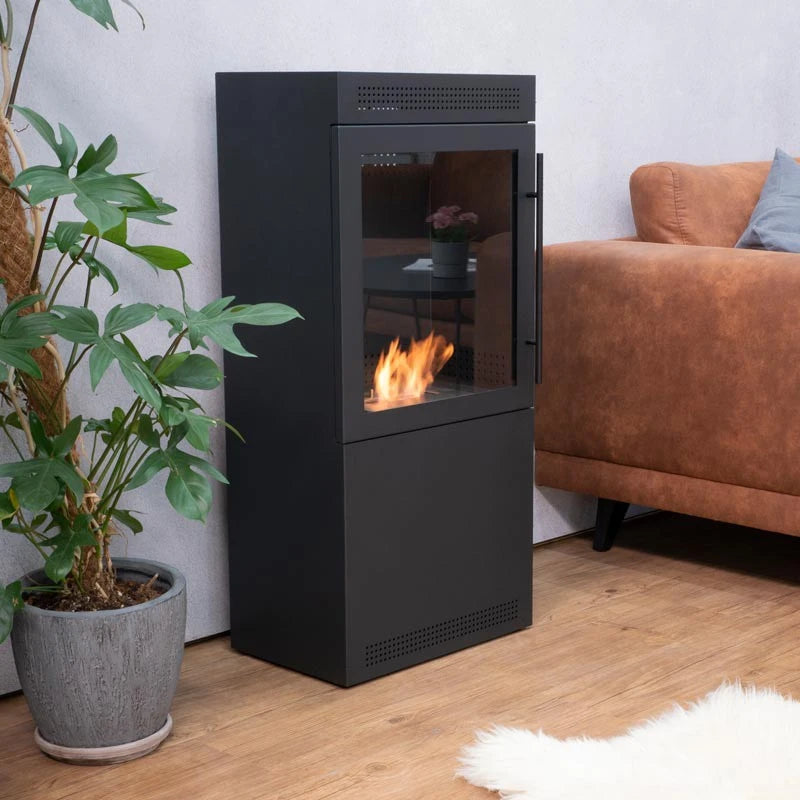 Jackson bioethanol wood stove, lit flame, living room with tan leather sofa and plant