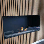 Foco One 1000 built into a light oak wood-slat wall with a lit flame, trade showroom photo